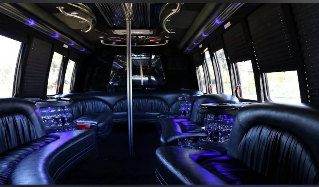 Spacious party bus interior with leather seating and ambient lighting